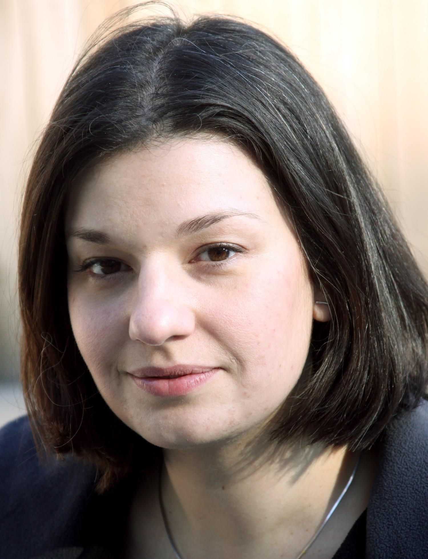 A portrait of a woman with a bob looking into the camera.