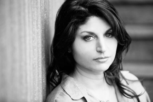 Sari Gilman looks at the camera. Photo in black and white.