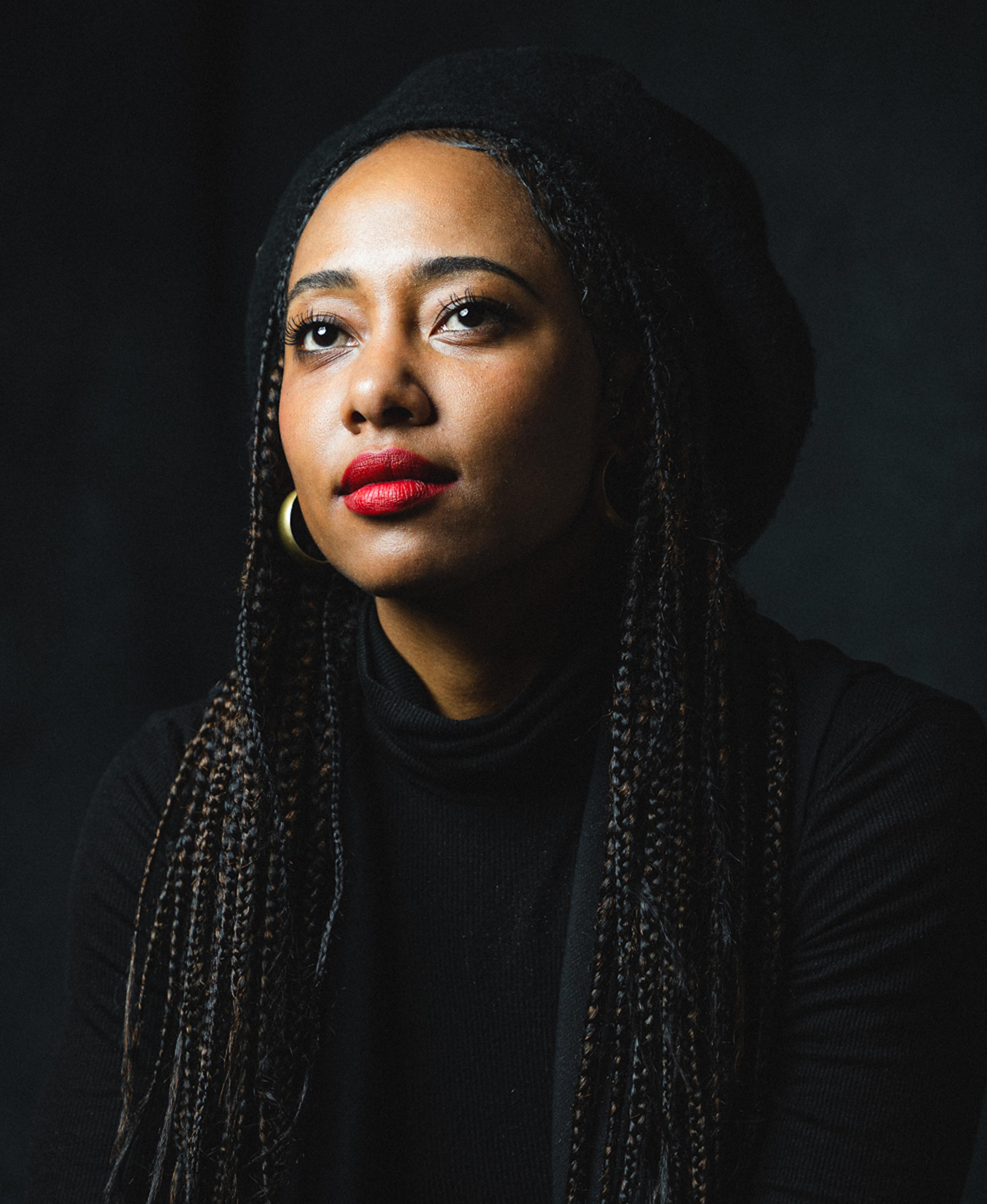 A headshot of filmmaker Contessa Gayles in a black turtleneck.