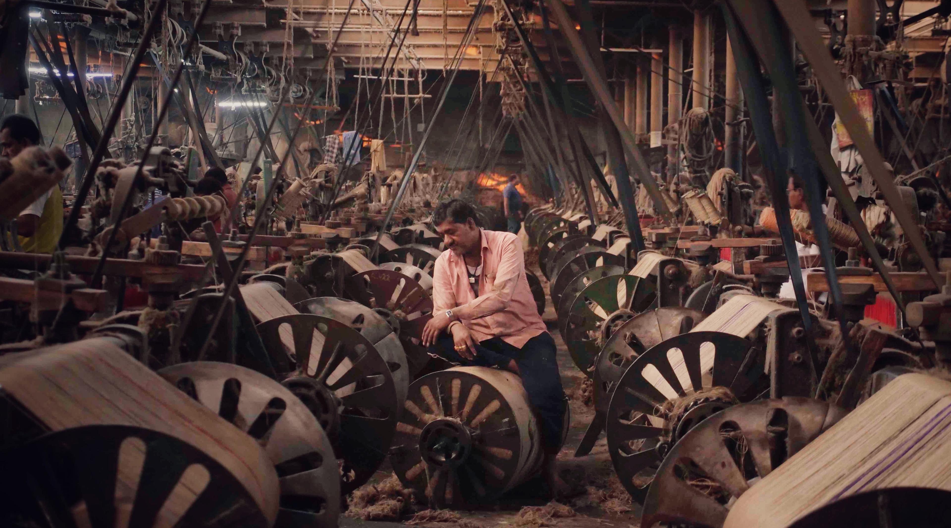 A man is working in a thread factory.
