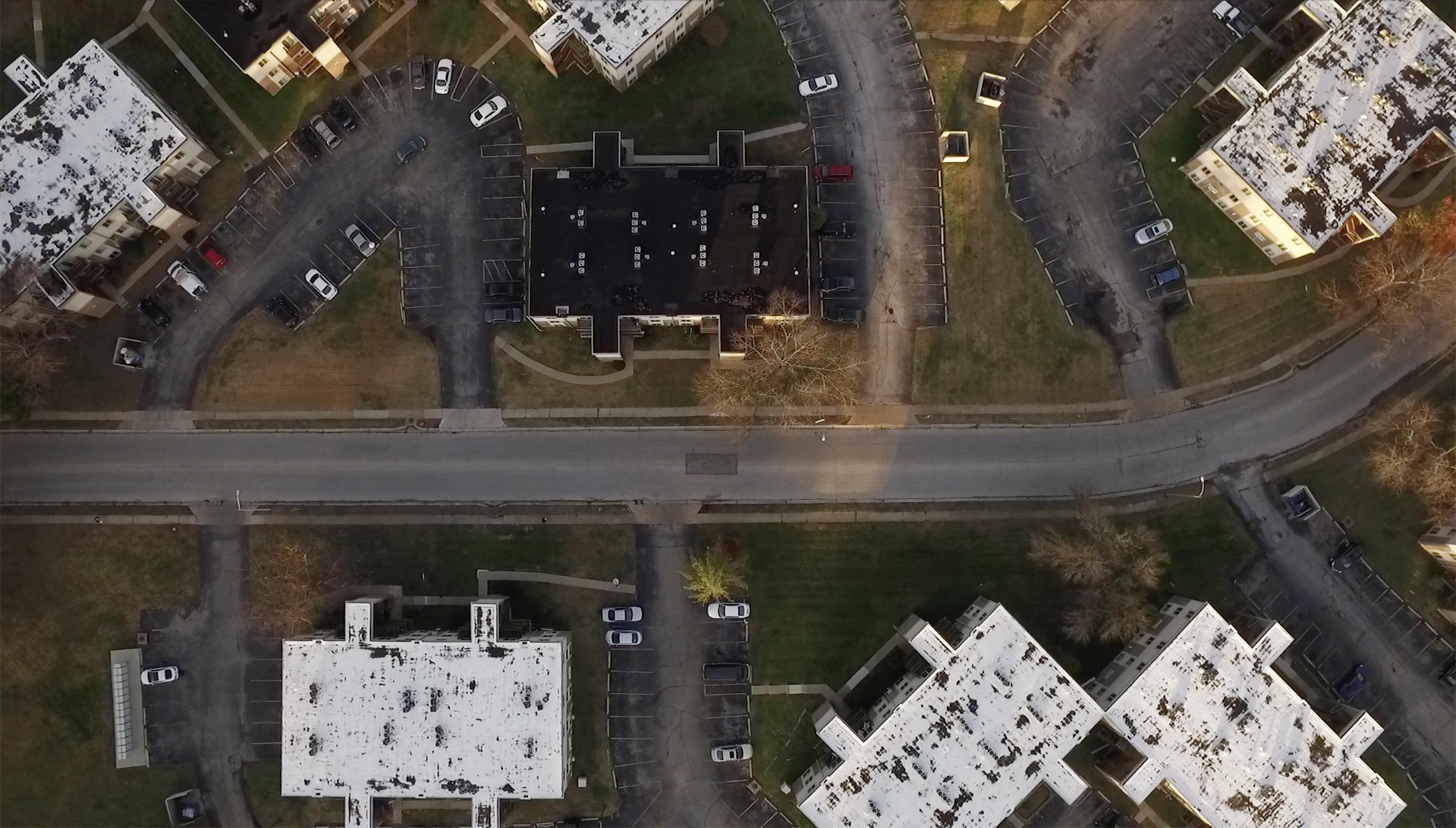 Still from The Rashomon Effect. Arial shot of a neighborhood.