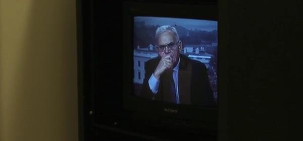 A television screen showing Edward Luttwak on the news.